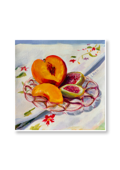 Sliced peaches and figs on a decorative plate with a floral tablecloth